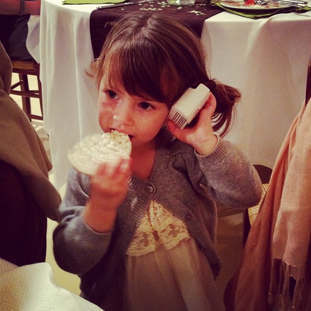 Caroline is talking on a disposable camera... phone