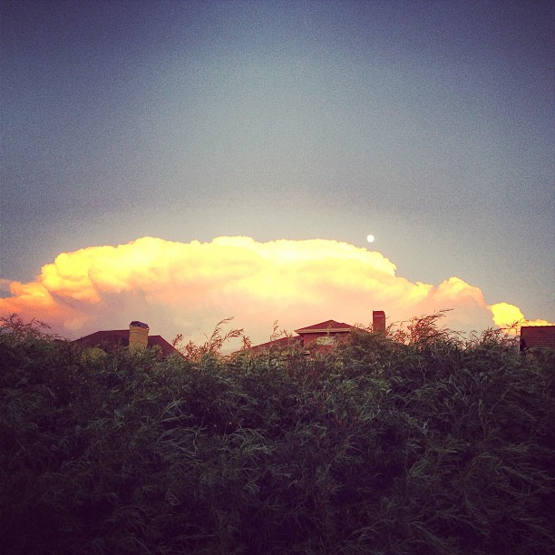 Huge cloud with the moon rising behind it.